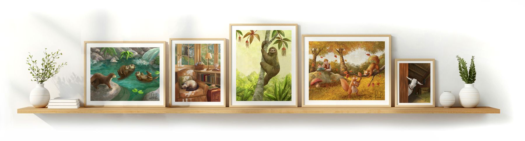A wooden shelf displaying five framed illustration art prints, including otters, a sleeping cat, a sloth, squirrels, and a goat.